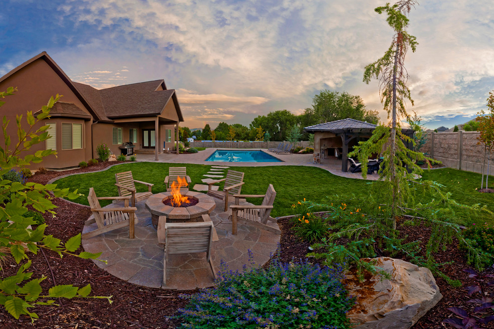 Large tuscan backyard concrete paver patio photo in Salt Lake City with a fire pit and no cover