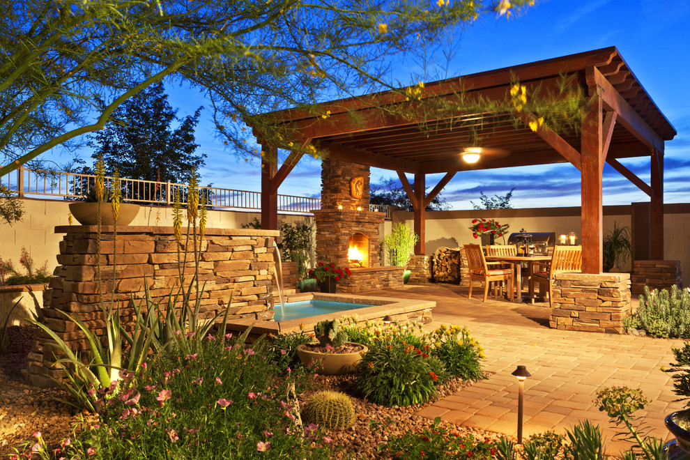 Inspiration for a large traditional back patio in Phoenix with a fire feature, concrete paving and a pergola.