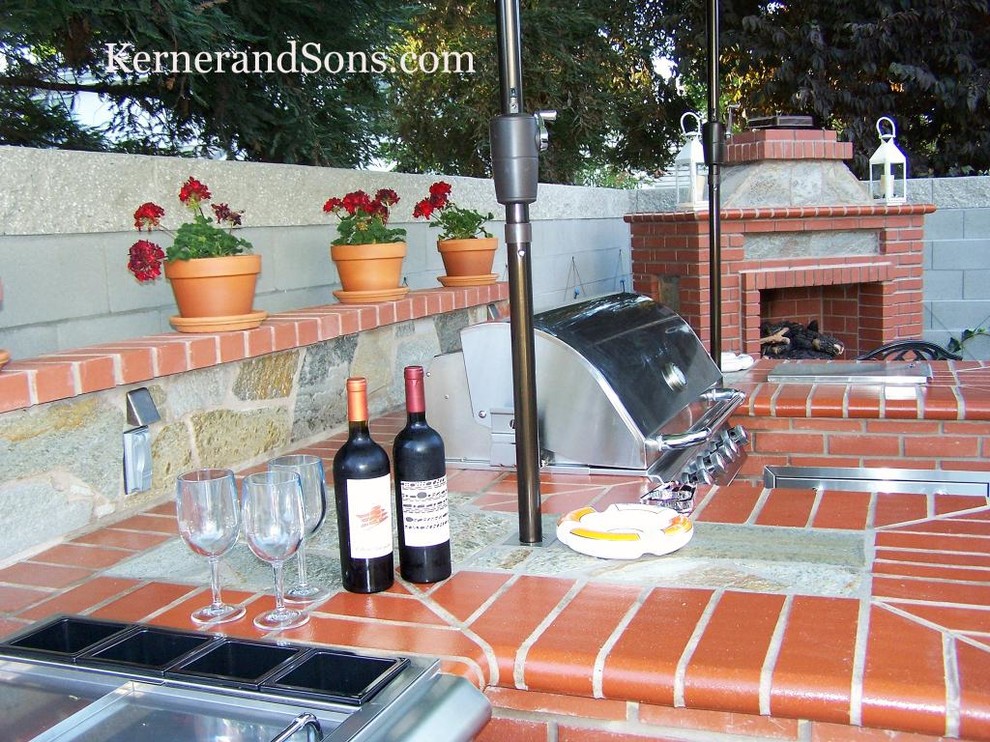 Inspiration for a large craftsman backyard concrete patio kitchen remodel in Other with no cover