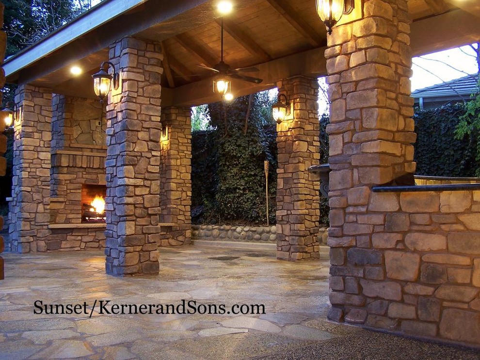 Design ideas for a large rustic back patio in Other with an outdoor kitchen, natural stone paving and a gazebo.