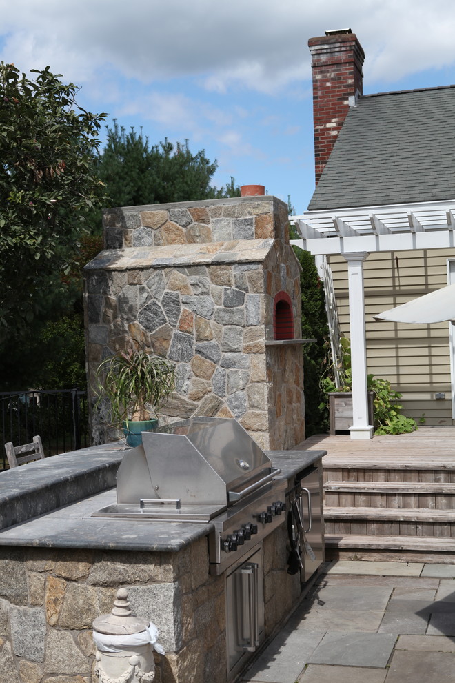 Idées déco pour une terrasse arrière classique avec une cuisine d'été et une pergola.