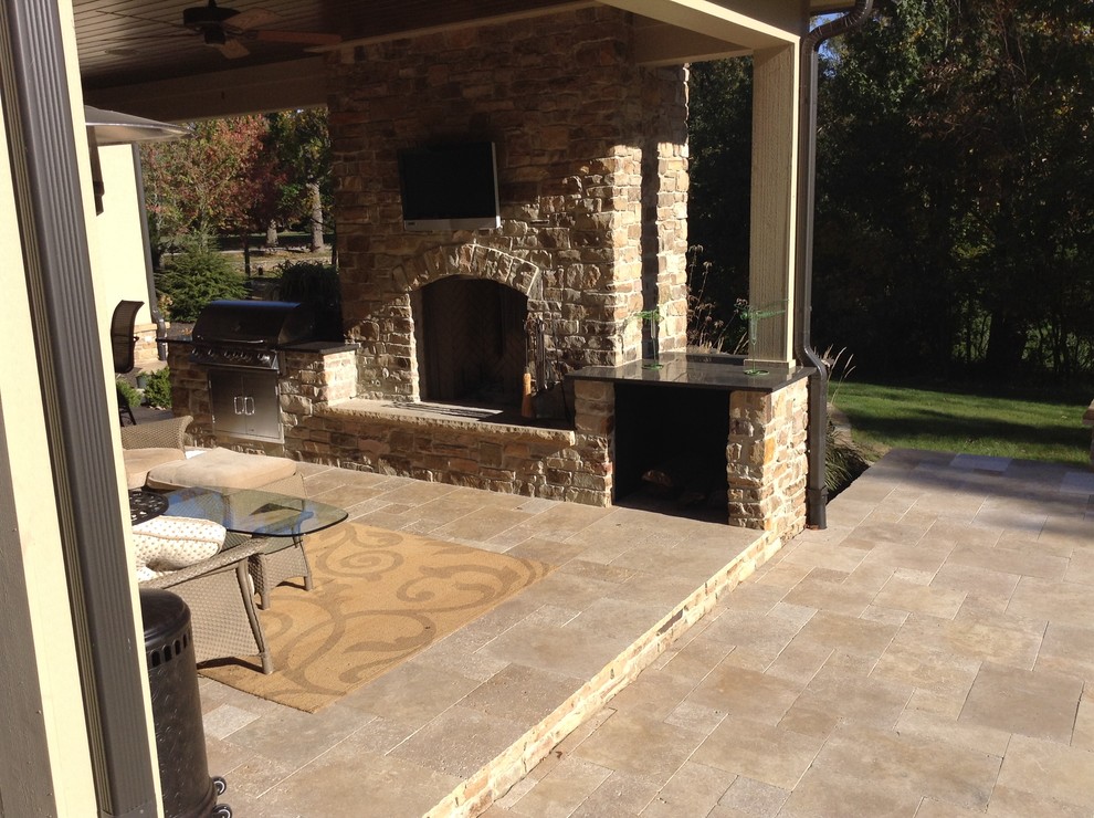 Design ideas for a large classic back patio in Indianapolis with a fire feature and natural stone paving.