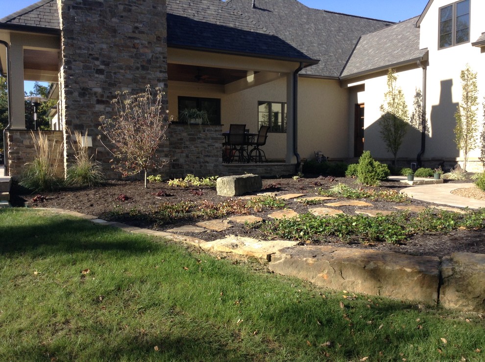 Foto di un grande patio o portico chic dietro casa con un focolare e pavimentazioni in pietra naturale