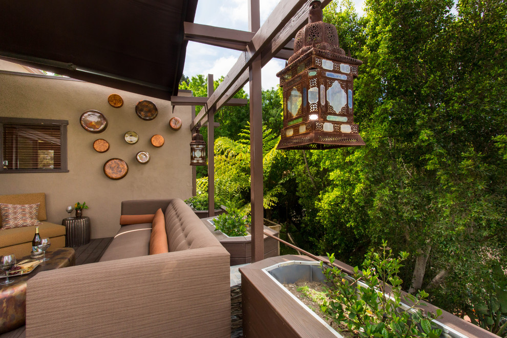Large tuscan patio photo in Los Angeles with decking and an awning