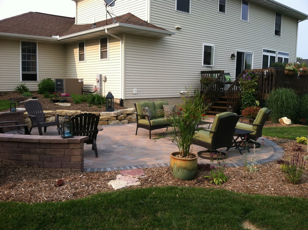 This is an example of a medium sized traditional back patio in Chicago with concrete paving.