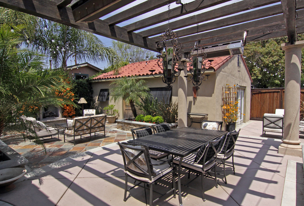 Tuscan patio photo in Orange County with a fire pit and a pergola