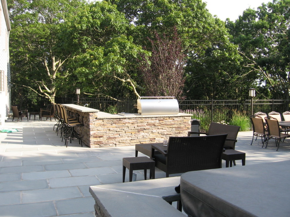 Idee per un patio o portico tradizionale nel cortile laterale con pavimentazioni in pietra naturale