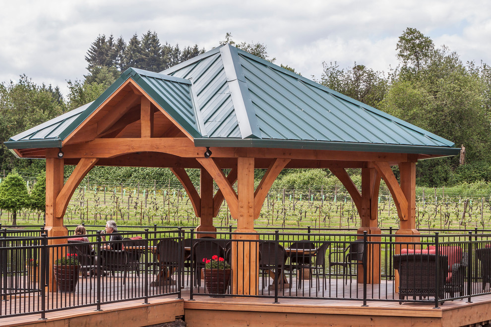 Example of a large mountain style backyard patio design in Portland with decking and a gazebo