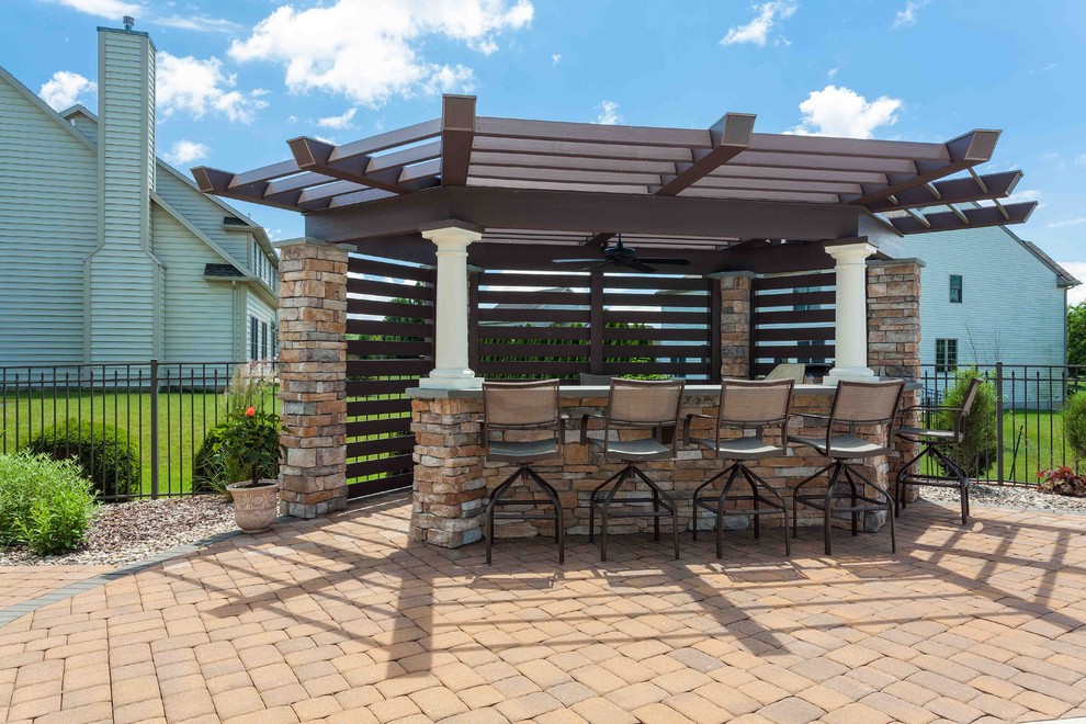 Design ideas for a medium sized world-inspired back patio in Other with an outdoor kitchen, brick paving and a pergola.