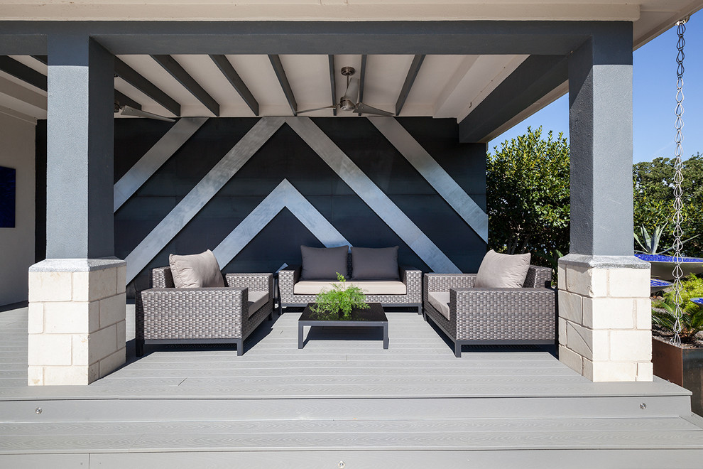 Cette image montre une grande terrasse arrière design avec une cuisine d'été, des pavés en béton et une extension de toiture.