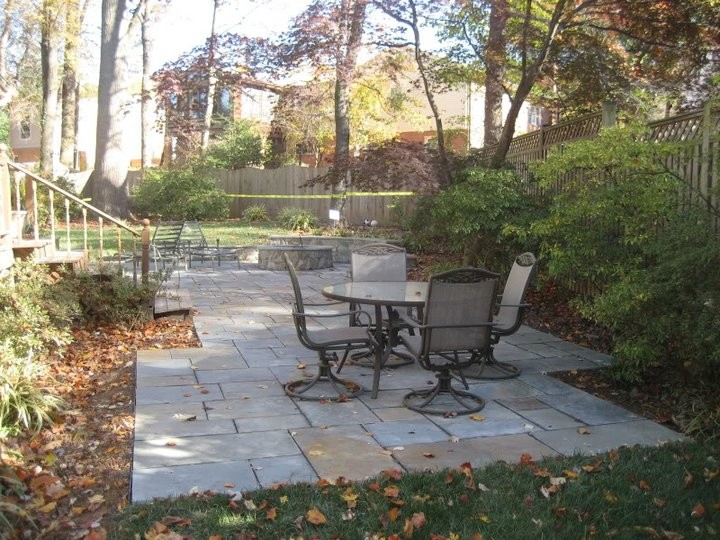 Example of a mid-sized classic backyard tile patio design in DC Metro with no cover