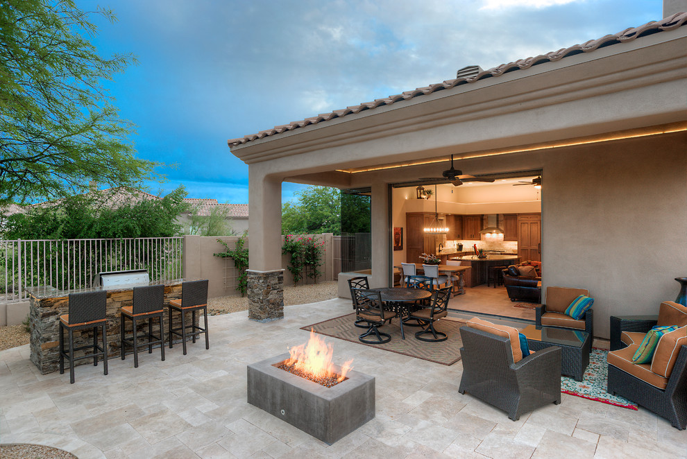 Large modern back patio in Phoenix with natural stone paving and a roof extension.