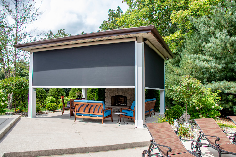 Photo of a medium sized back patio in St Louis with concrete slabs and a gazebo.