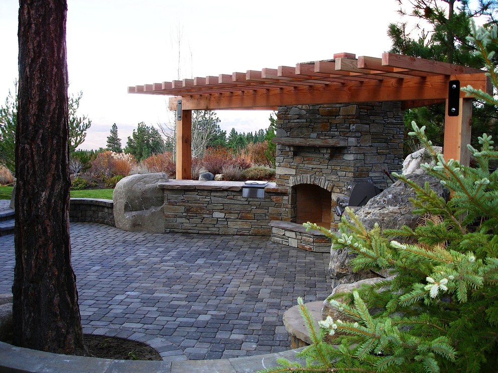 Photo of a medium sized rustic back patio in Other with an outdoor kitchen, concrete paving and a pergola.