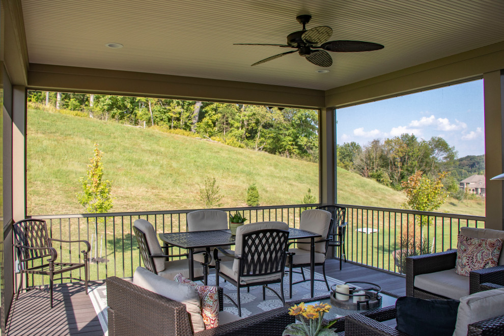 Example of a mid-sized backyard stamped concrete patio design in St Louis with a fire pit and a roof extension