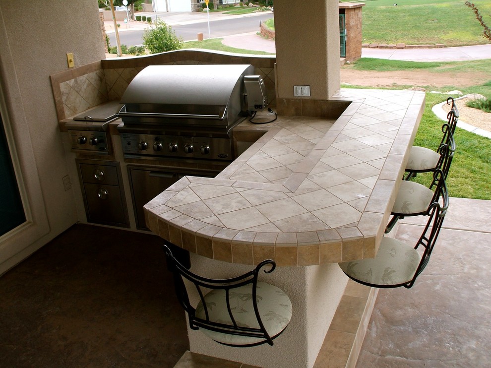 Inspiration for a mid-sized timeless backyard concrete patio kitchen remodel in Salt Lake City with a roof extension