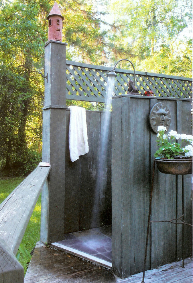 Example of an island style outdoor patio shower design in New Orleans with decking and no cover