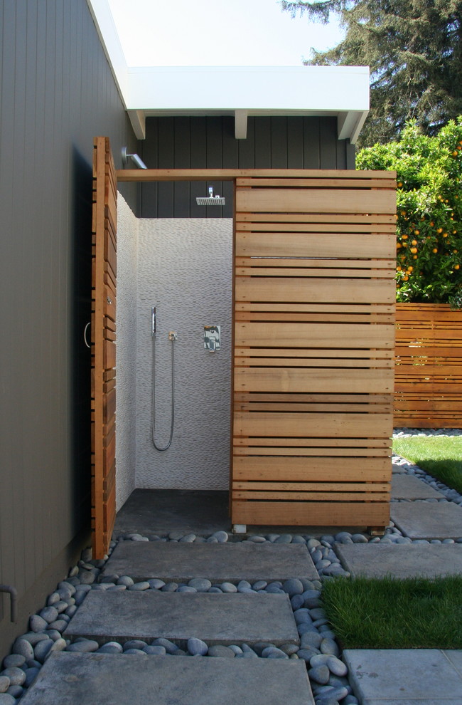This is an example of a medium sized midcentury back patio in San Francisco with concrete paving.