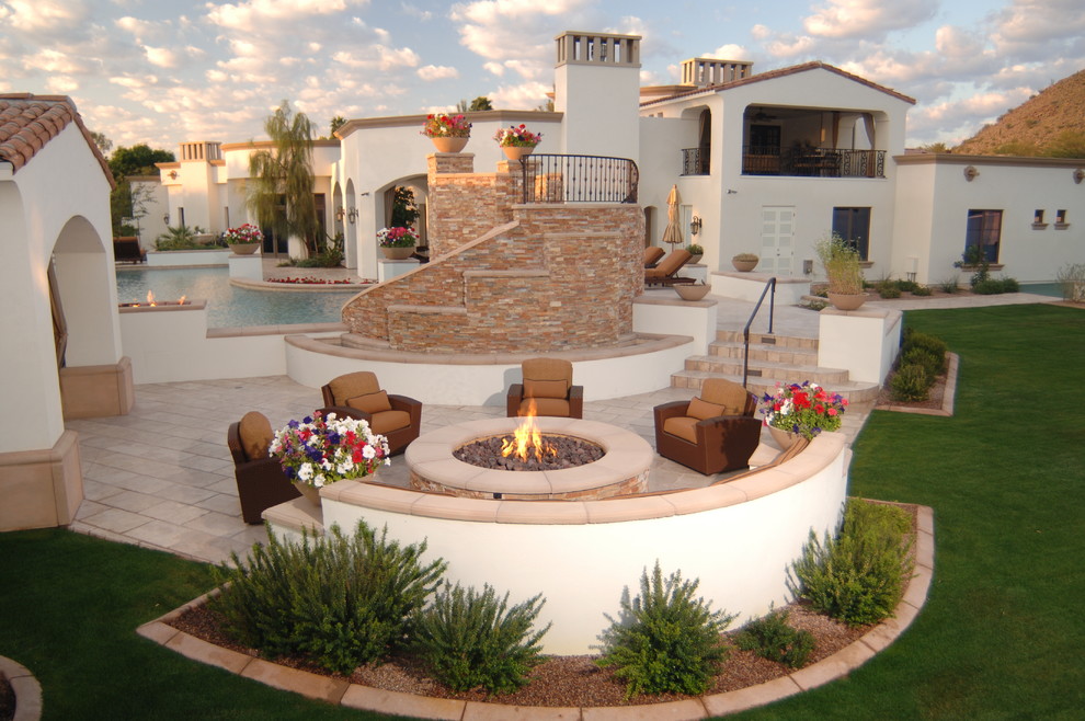 Example of a large tuscan backyard tile patio design in Phoenix with a fire pit and no cover