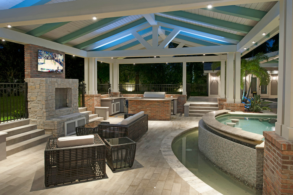 Design ideas for a large traditional back patio in Tampa with a roof extension.