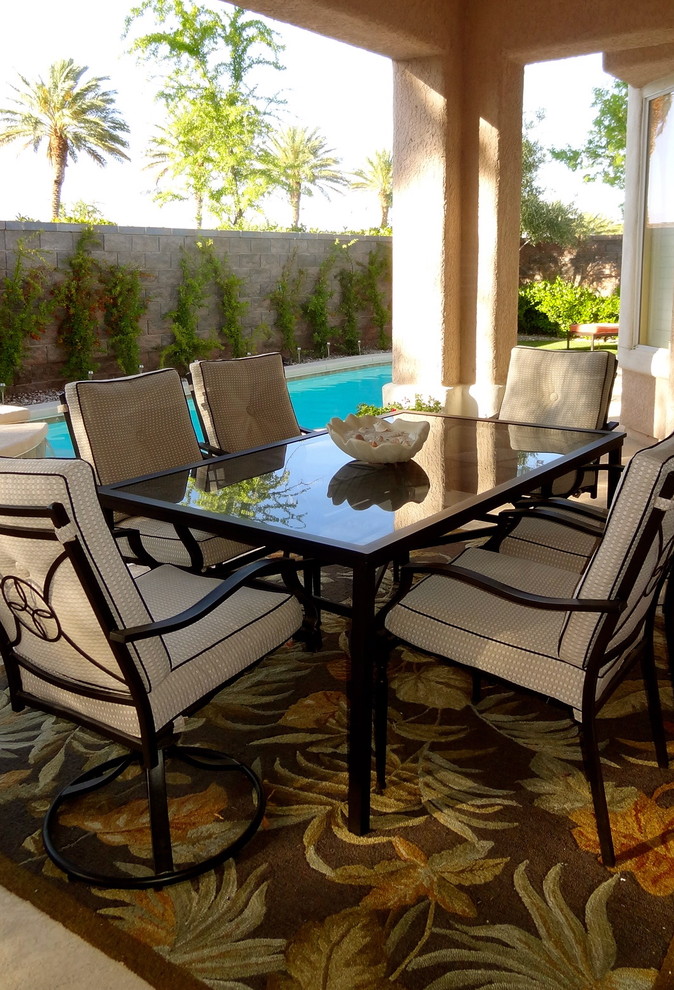 Inspiration for a mid-sized tropical backyard patio remodel in Las Vegas with a roof extension