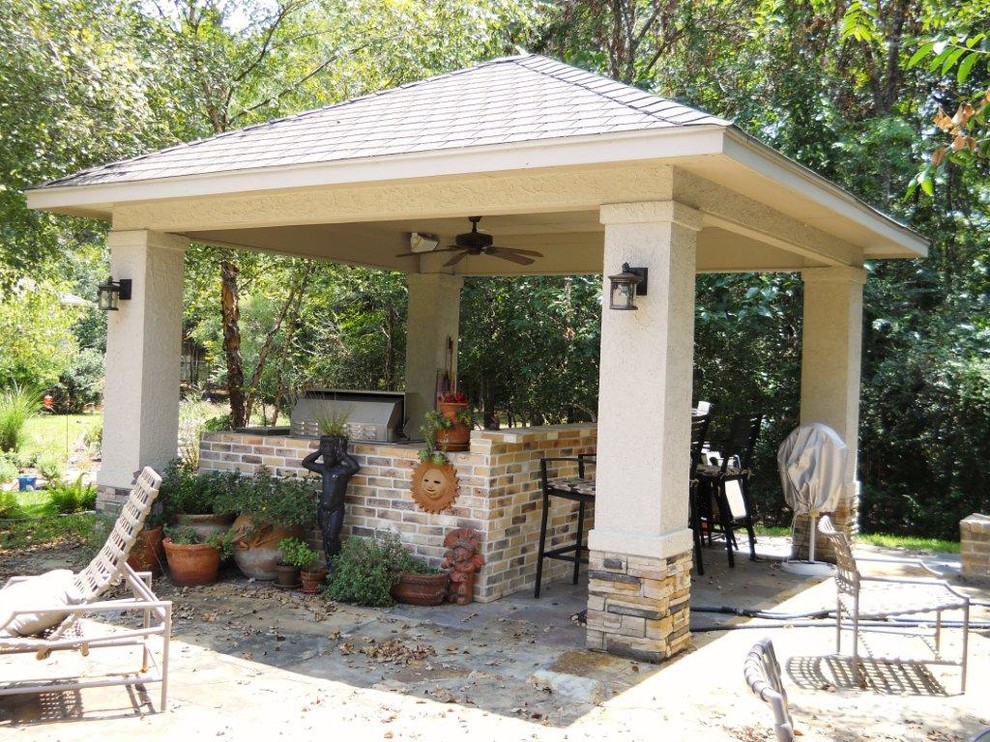 Inspiration for a large traditional back patio in Houston with an outdoor kitchen, brick paving and a gazebo.