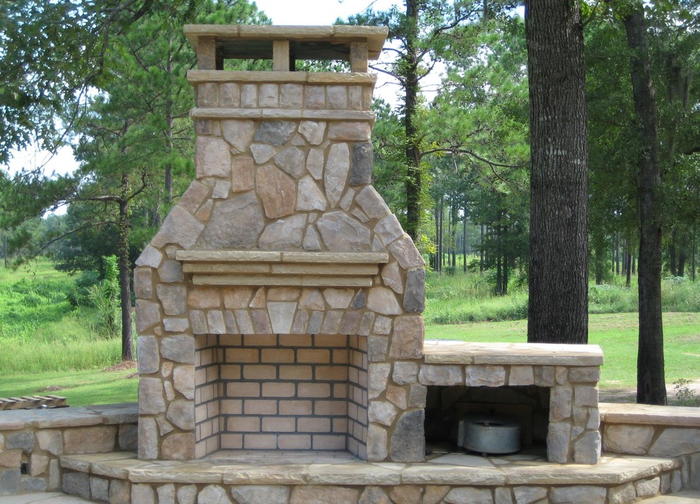 Medium sized rustic back patio in Atlanta with a fireplace, natural stone paving and no cover.