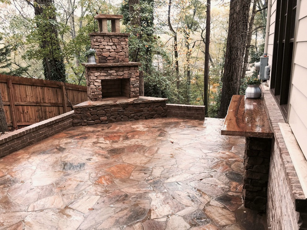 Design ideas for a medium sized rustic side patio in Atlanta with a fireplace, natural stone paving and no cover.