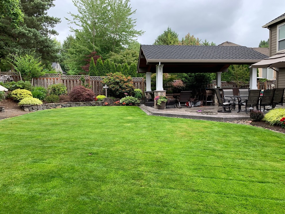 Inspiration for a mid-sized timeless backyard concrete paver patio remodel in Portland with a gazebo