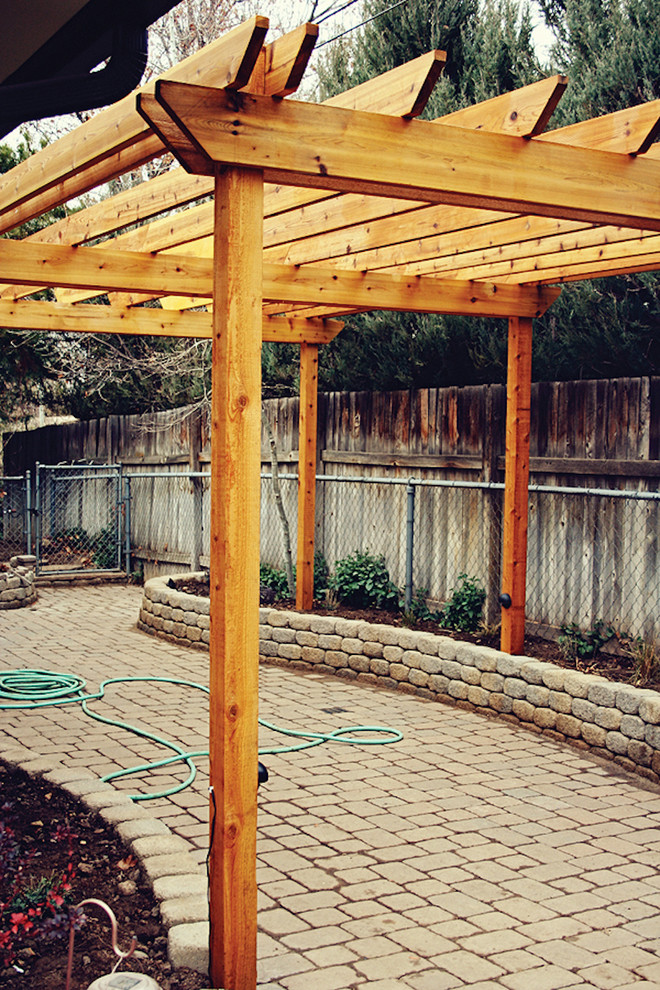 Example of a mid-sized arts and crafts backyard concrete patio design in Salt Lake City with a pergola