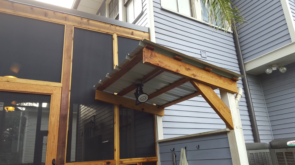 Example of a small classic backyard outdoor patio shower design in New Orleans with a roof extension