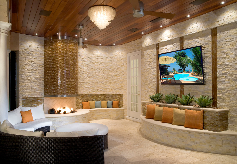 Patio - small traditional backyard stone patio idea in Tampa with a fire pit and a roof extension