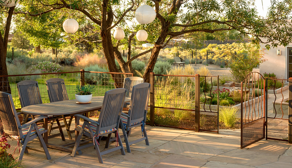 Example of an eclectic patio design in Albuquerque with no cover