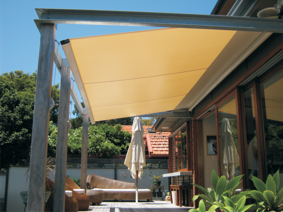 Example of a trendy backyard patio design in Sydney with an awning