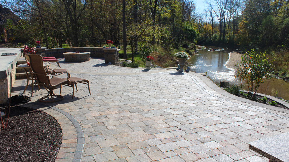 Example of a large classic backyard concrete paver patio design in Indianapolis with a fire pit and no cover