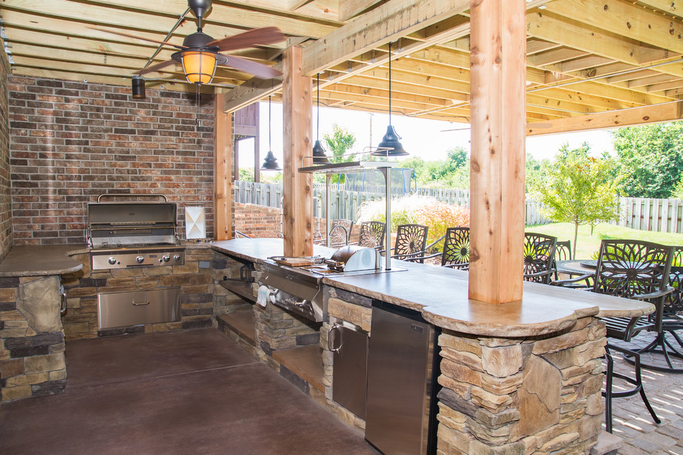 Inspiration pour une terrasse arrière chalet de taille moyenne avec une cuisine d'été, une dalle de béton et une pergola.