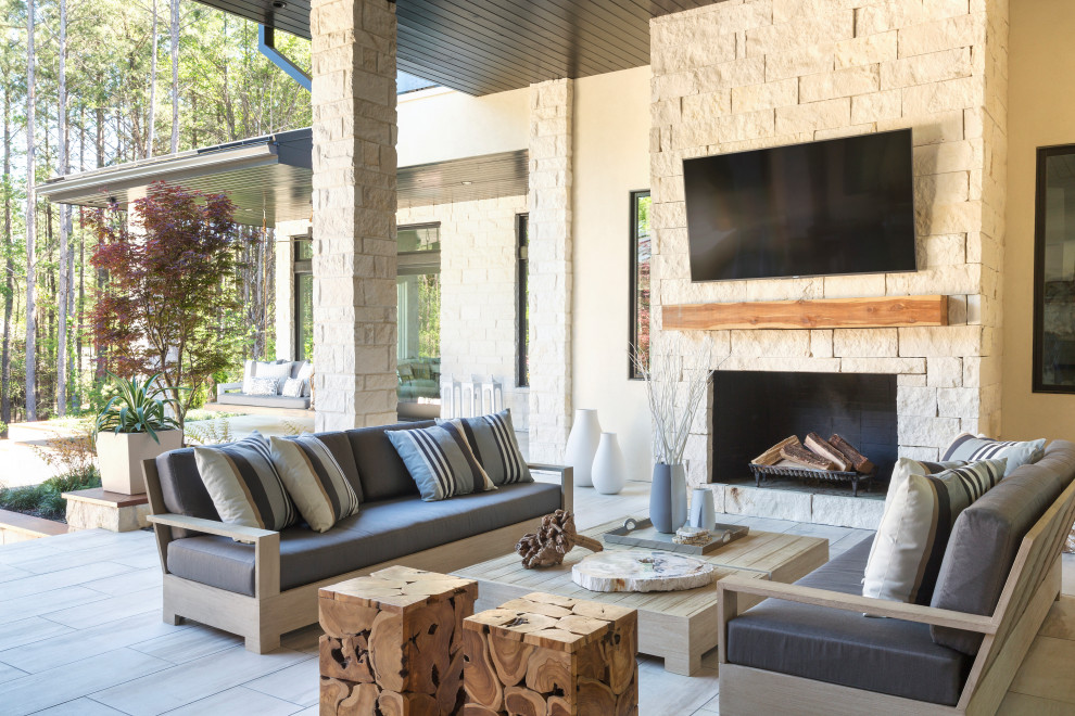 Inspiration for a contemporary tile patio remodel in Little Rock with a fireplace and a roof extension