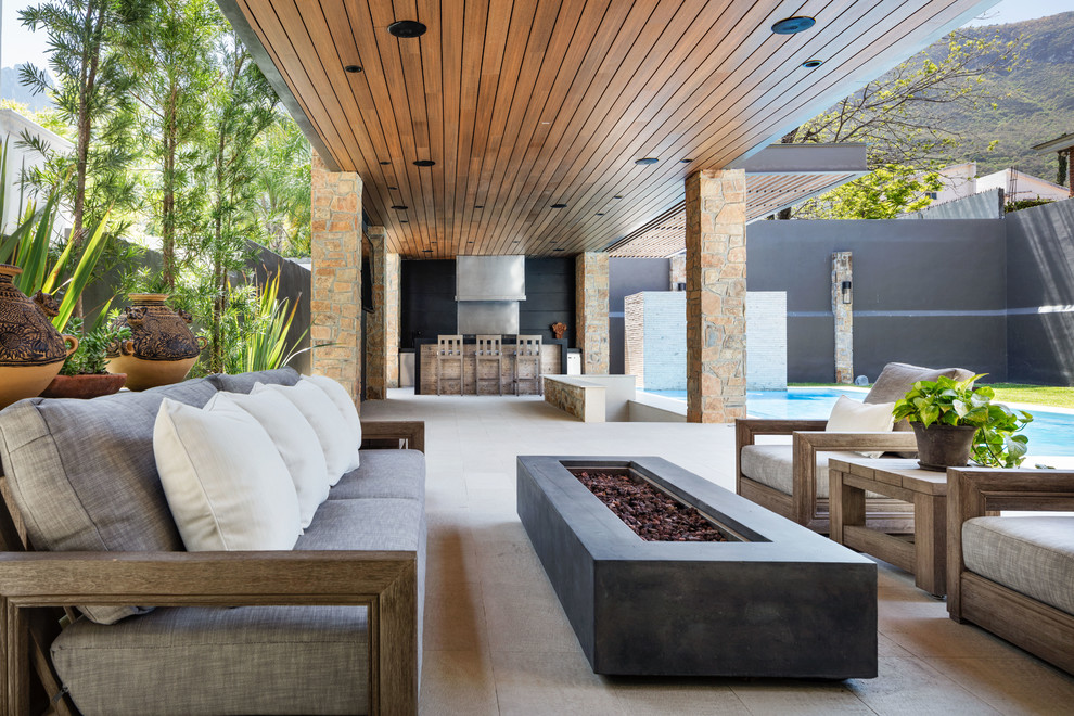 Inspiration for a contemporary backyard patio remodel with a roof extension