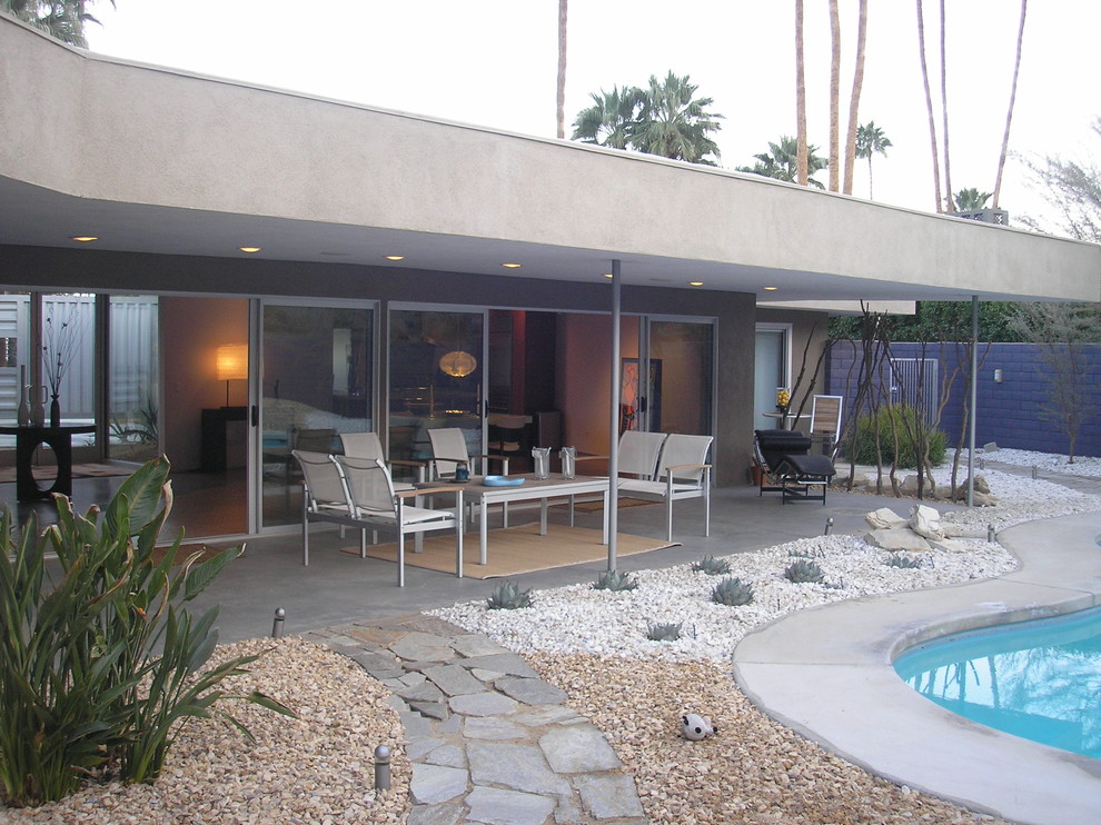 Идея дизайна: двор на заднем дворе в стиле модернизм с покрытием из бетонных плит и навесом