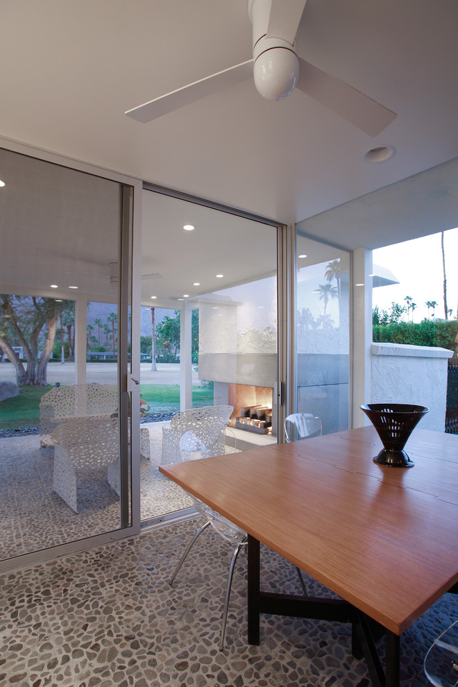 This is an example of a midcentury patio in Los Angeles with a fire feature.