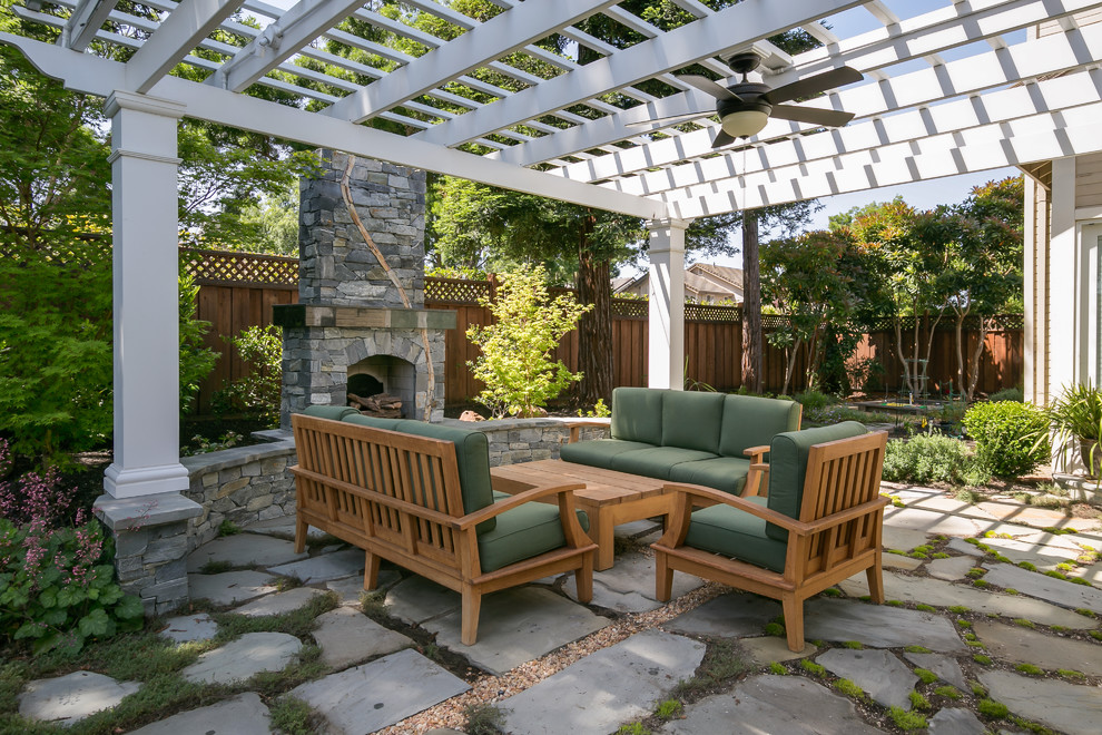 Medium sized traditional back patio in San Francisco with a fire feature, natural stone paving and a pergola.