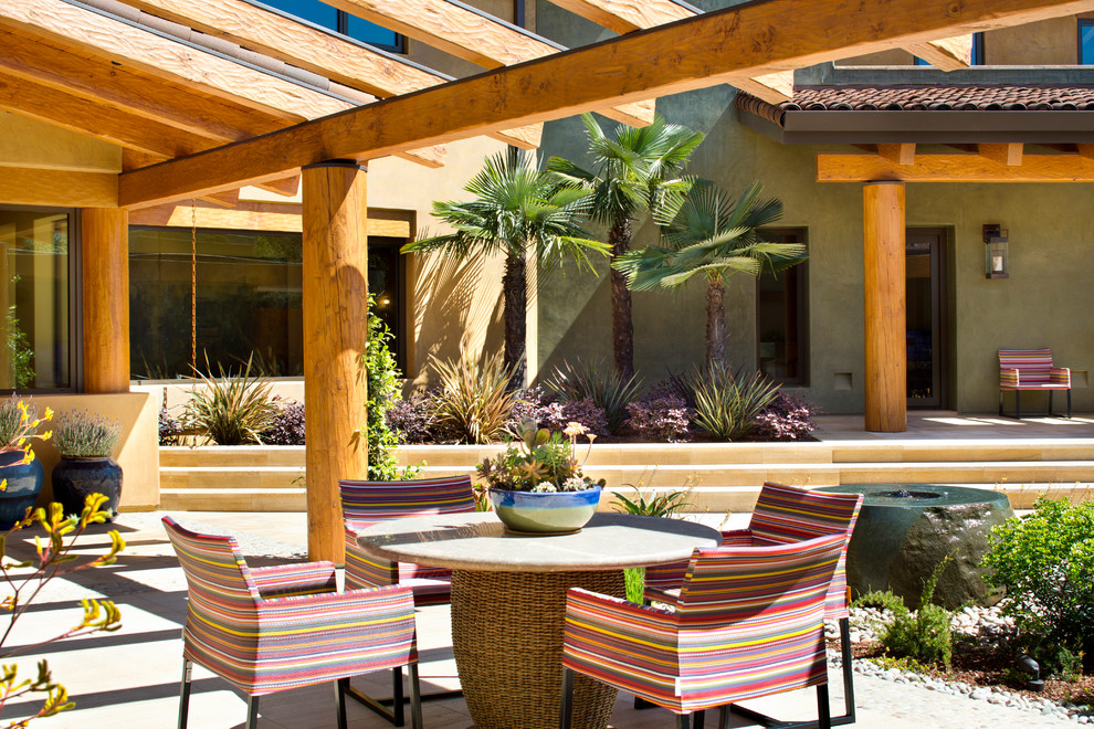 Inspiration for a large southwestern backyard tile patio fountain remodel in San Francisco with a pergola