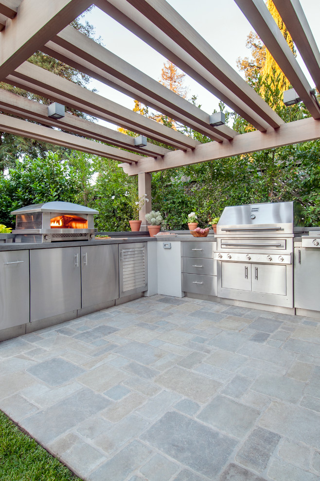 Photo of a large back patio in San Francisco with an outdoor kitchen and a pergola.