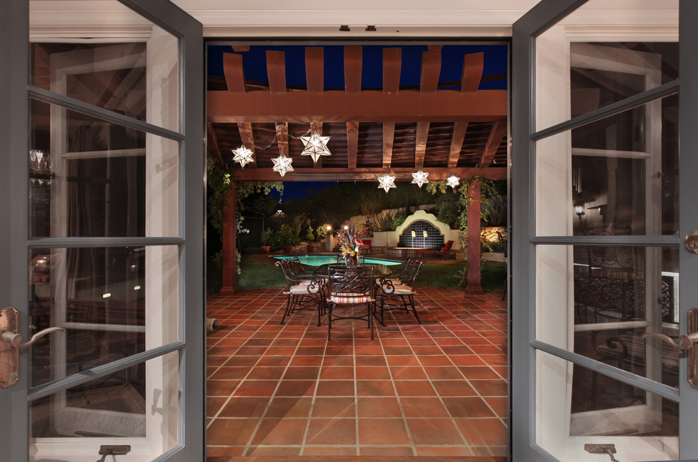Inspiration for a large mediterranean back patio in Los Angeles with an outdoor kitchen, tiled flooring and a pergola.