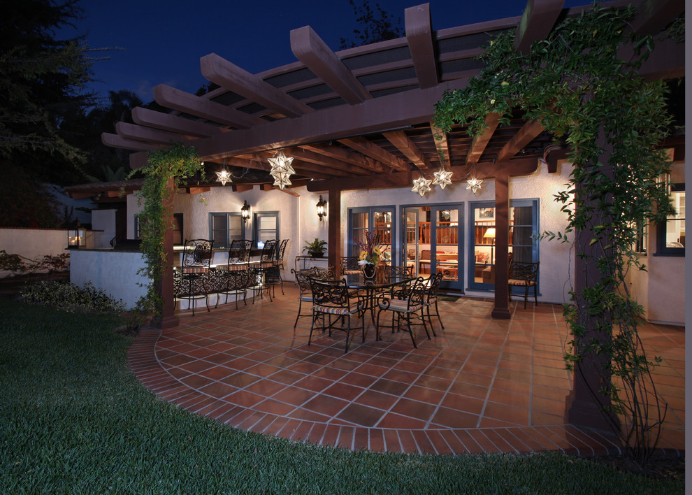 Large mediterranean back patio in Los Angeles with tiled flooring, a pergola and an outdoor kitchen.