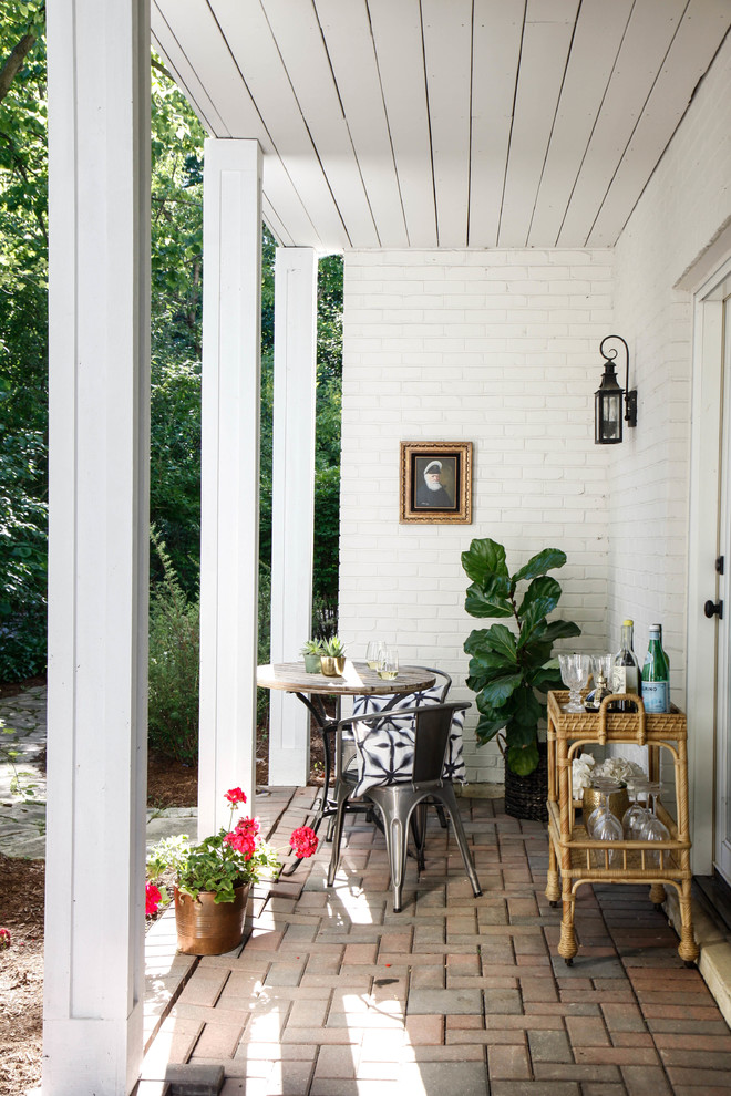 Inspiration for a transitional brick patio remodel in Chicago with a roof extension
