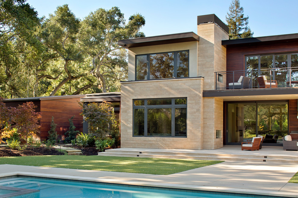 Inspiration pour une grande terrasse arrière minimaliste avec une cuisine d'été, du béton estampé et une extension de toiture.