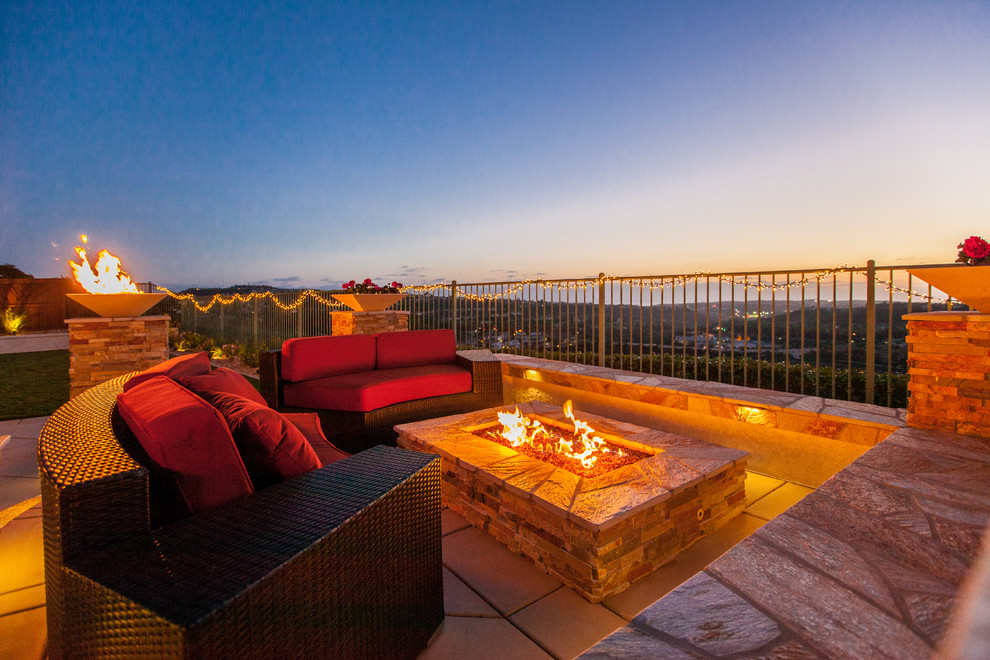 Inspiration for a mid-sized coastal backyard patio remodel in San Diego with a fire pit