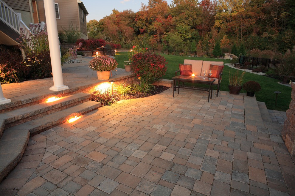 Large classic back patio in Philadelphia with a fire feature, concrete paving and a gazebo.