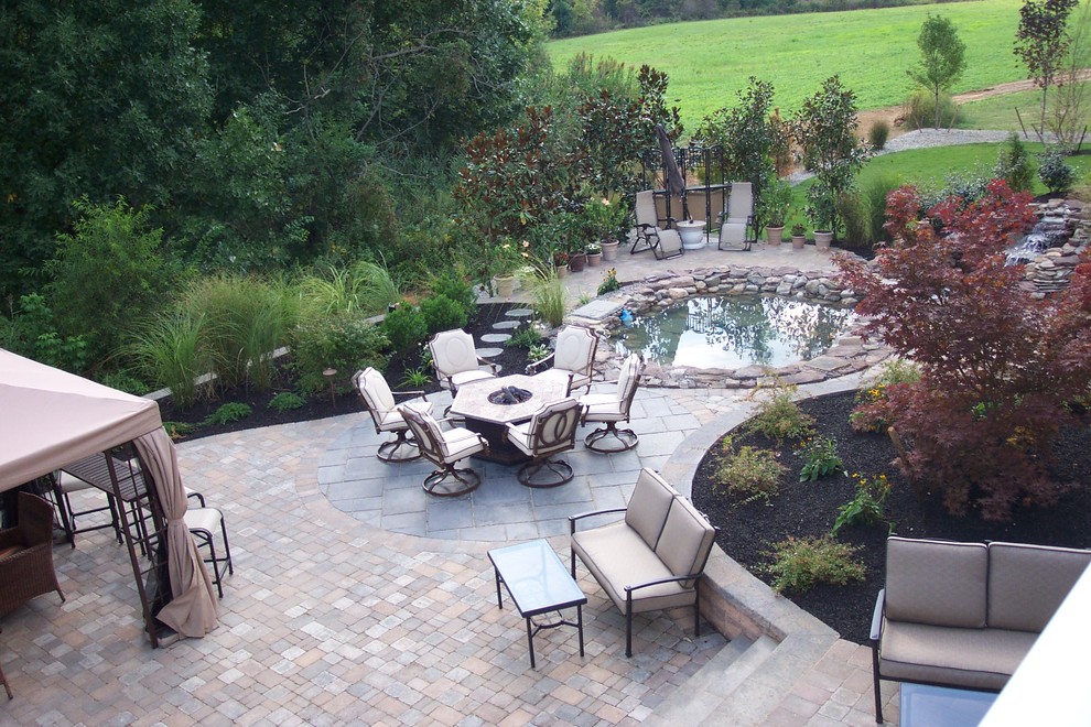 Design ideas for a large classic back patio in Philadelphia with concrete paving, a gazebo and a fire feature.